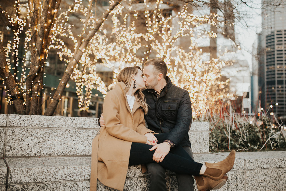  Couple sitting in downtown Chicago with string lights background 