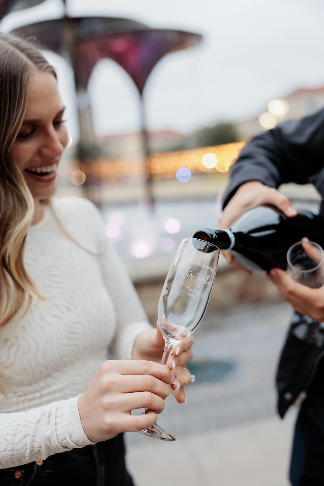 couple pouring champagne | Texas Christian University Proposal