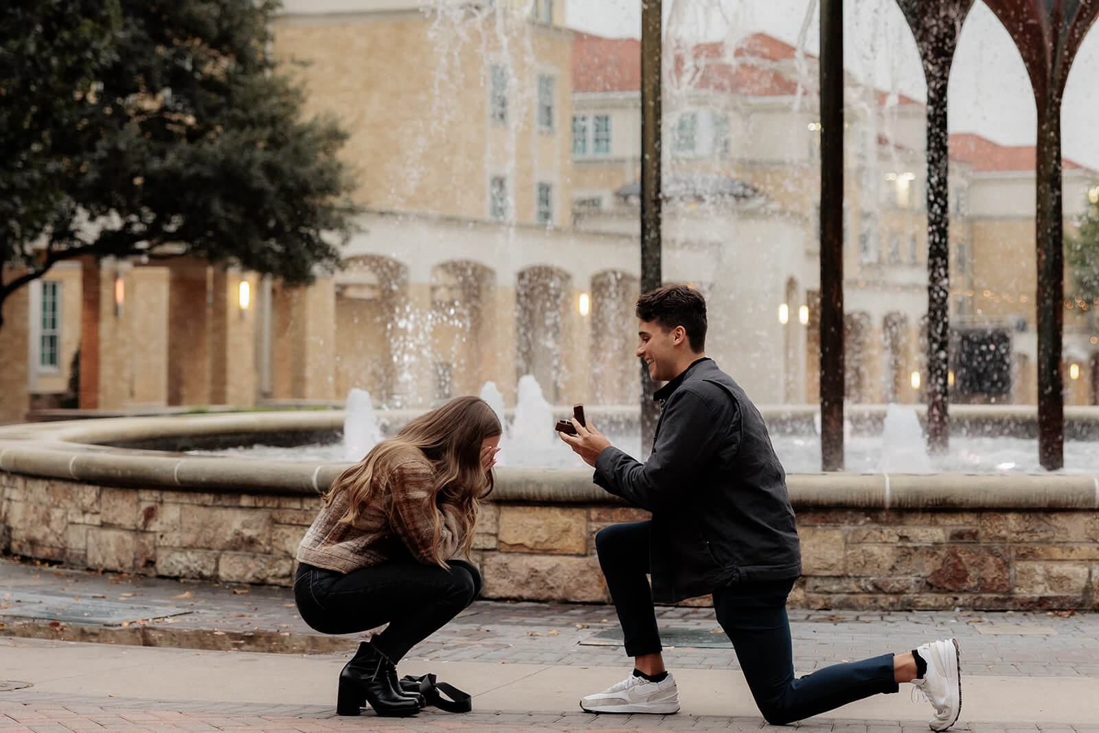 Man proposing on one knee in front of frog fountain | Texas Christian University Proposal