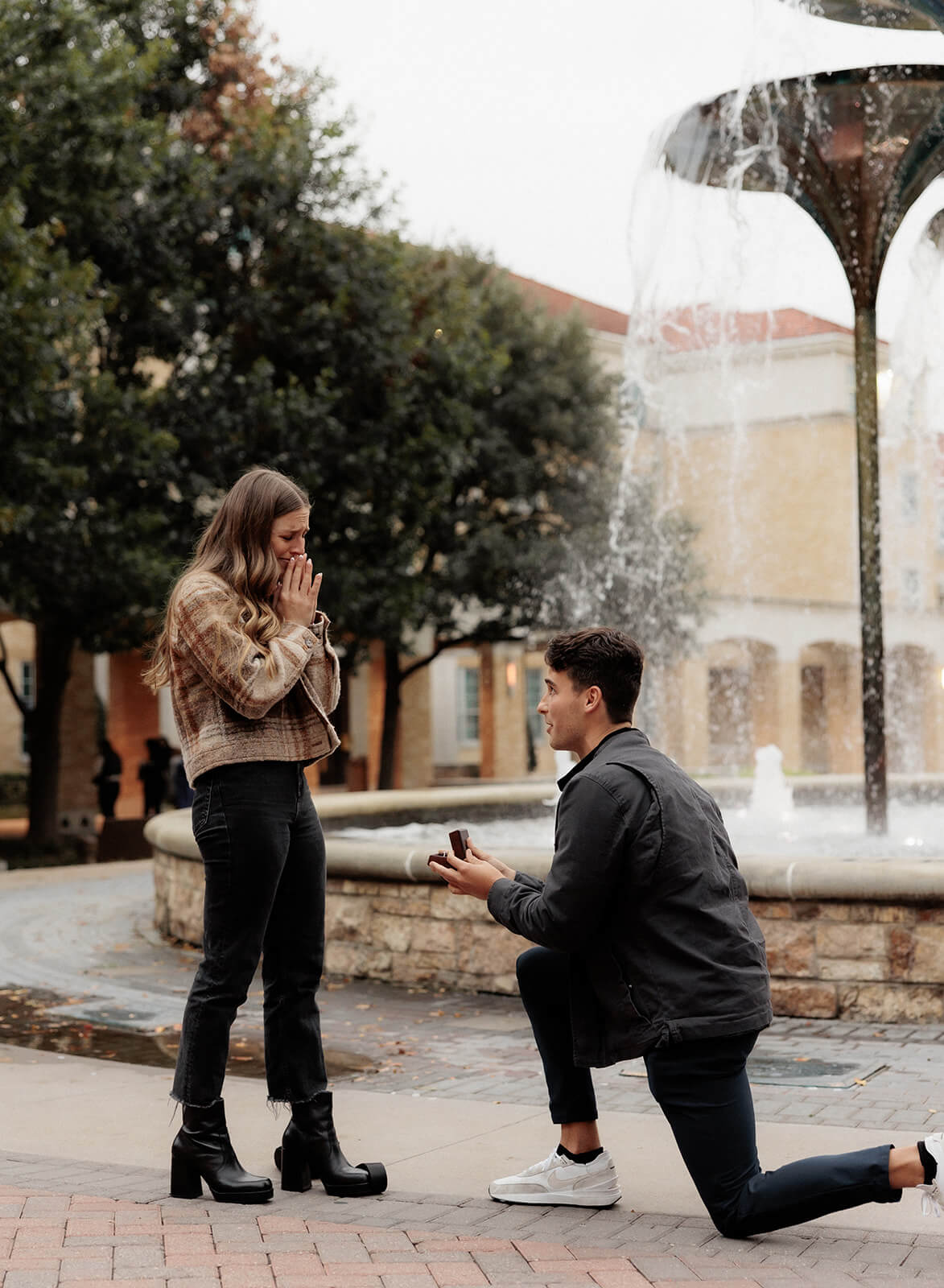 man proposing, girlfriend reacting in front of frog fountain | Texas Christian University Proposal