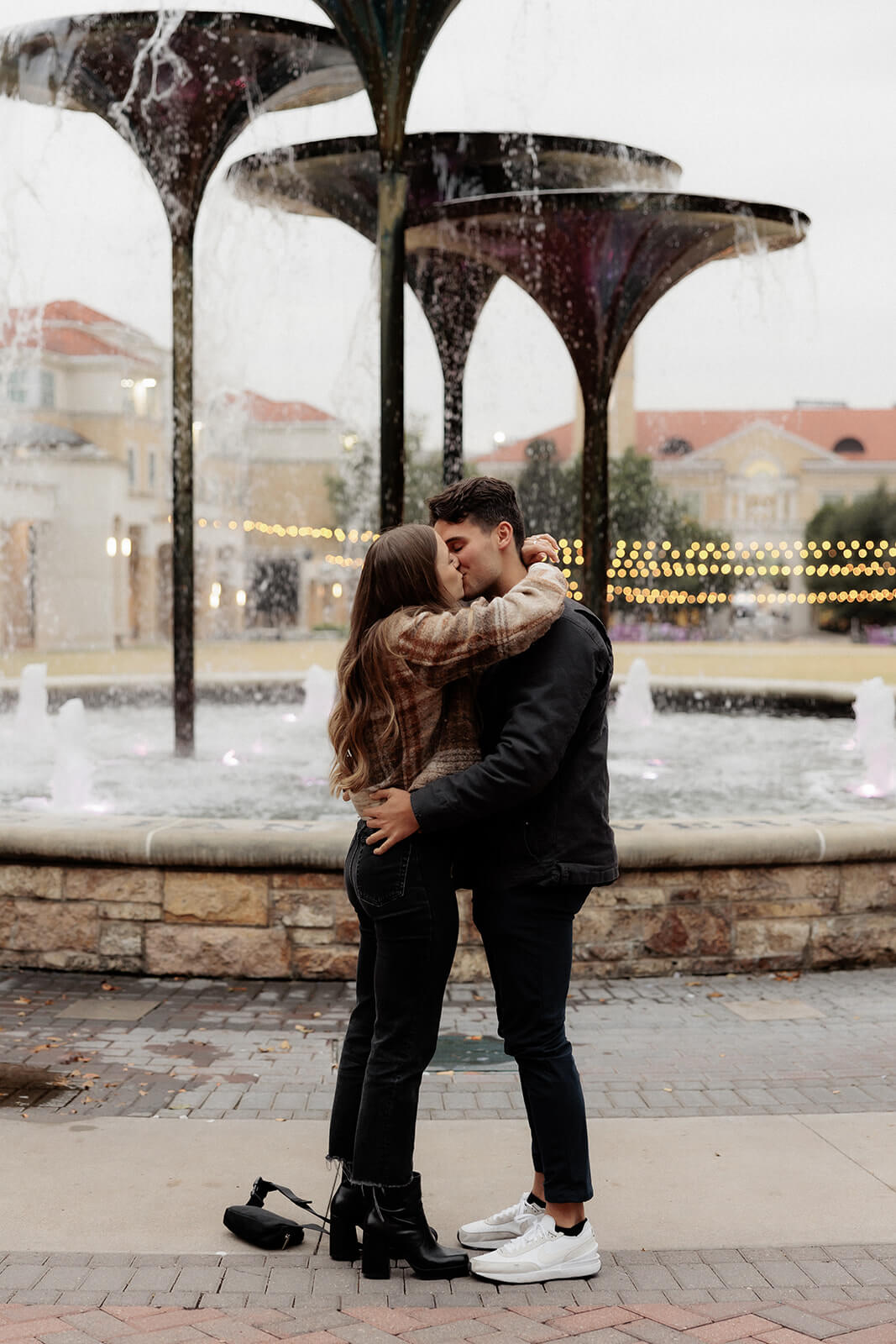 couple kissing after proposal in front of frog fountain | Texas Christian University Proposal