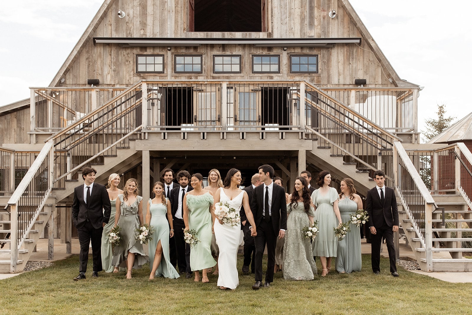 Bride and groom walk with their wedding party at their Bozeman wedding at Firelight Farm