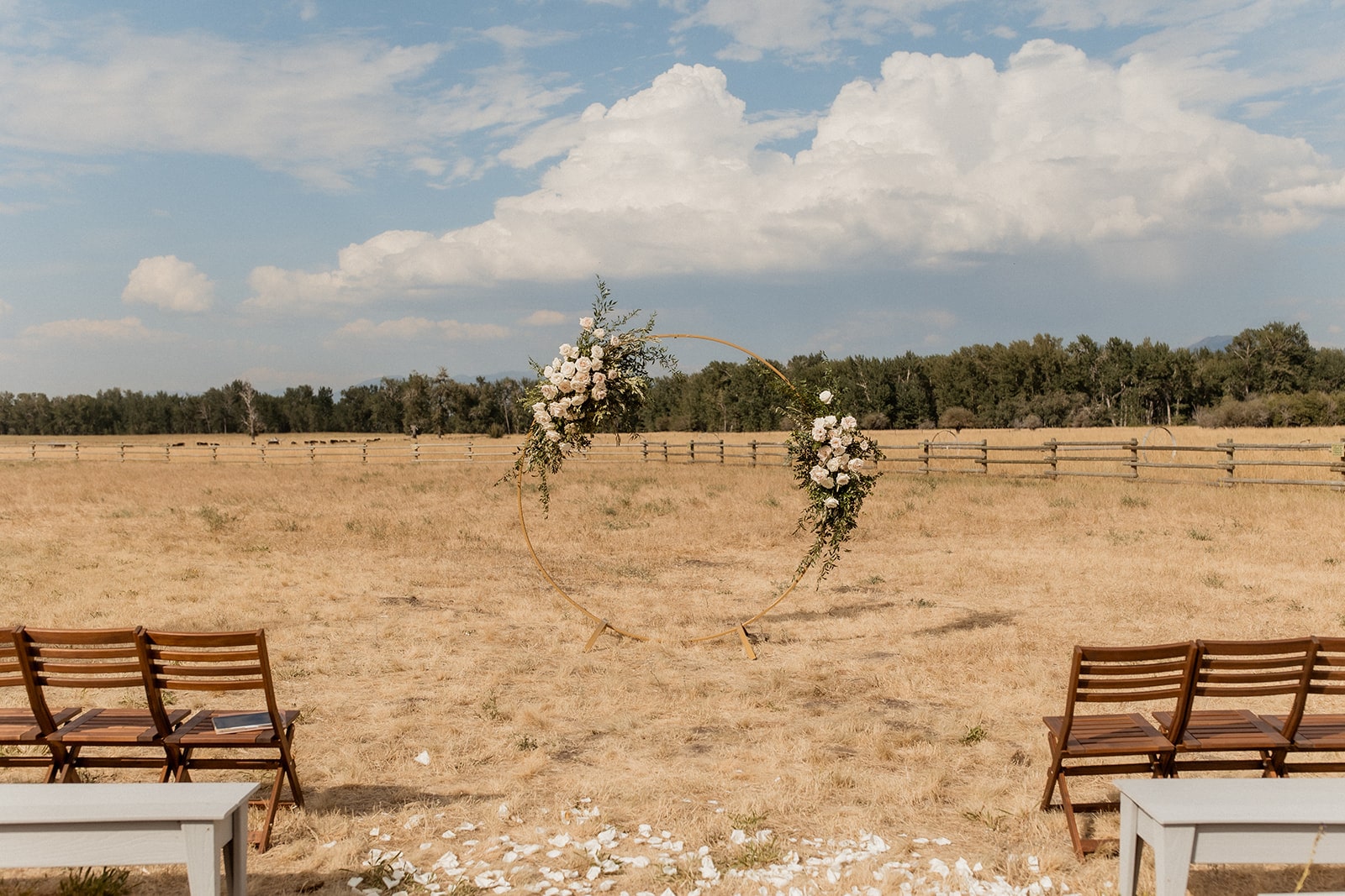 Gold circle arch in the middle of a field at Montana wedding 