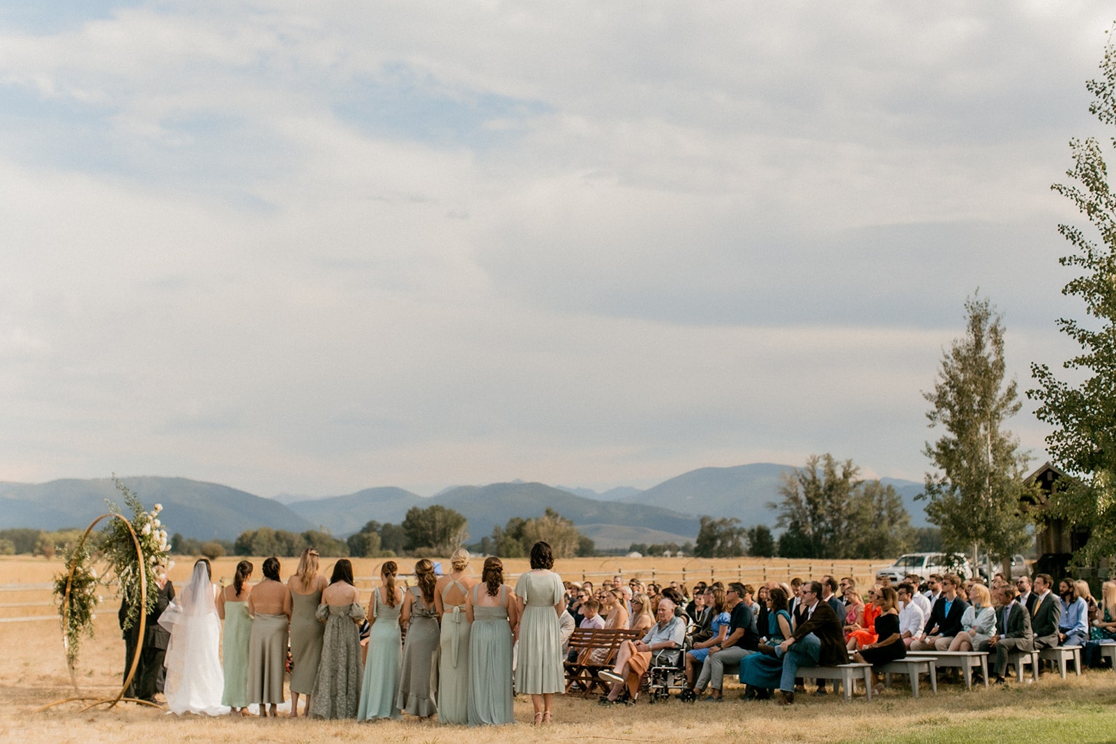 Guests sit at an outdoor wedding ceremony at Firelight Farm in Bozeman, Montana