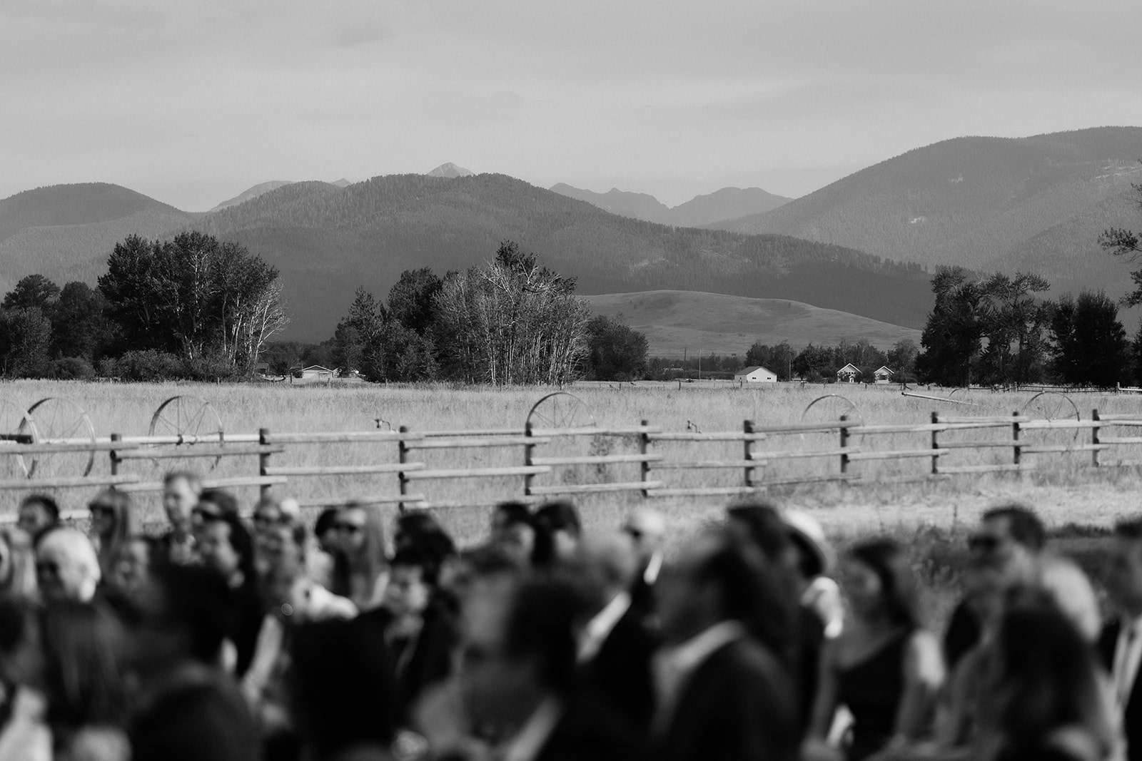 Guests sit at an outdoor wedding ceremony at Firelight Farm in Bozeman, Montana