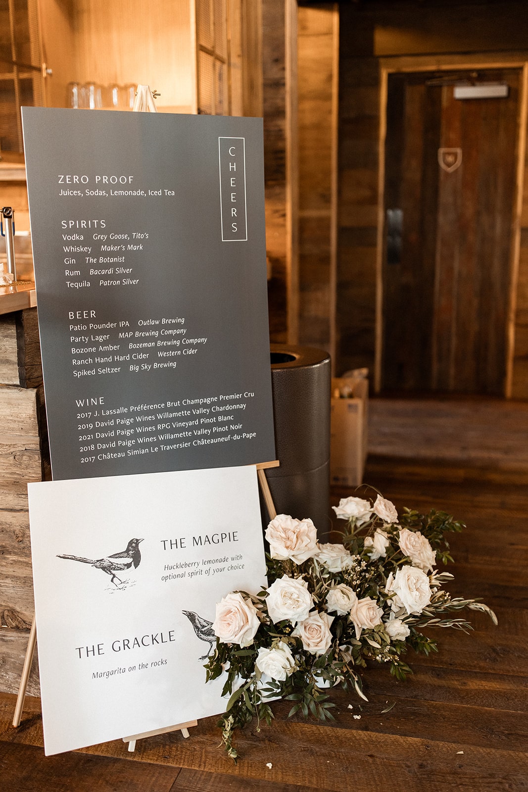 Black sign with alcohol drinks and signature cocktails named after Montana birds