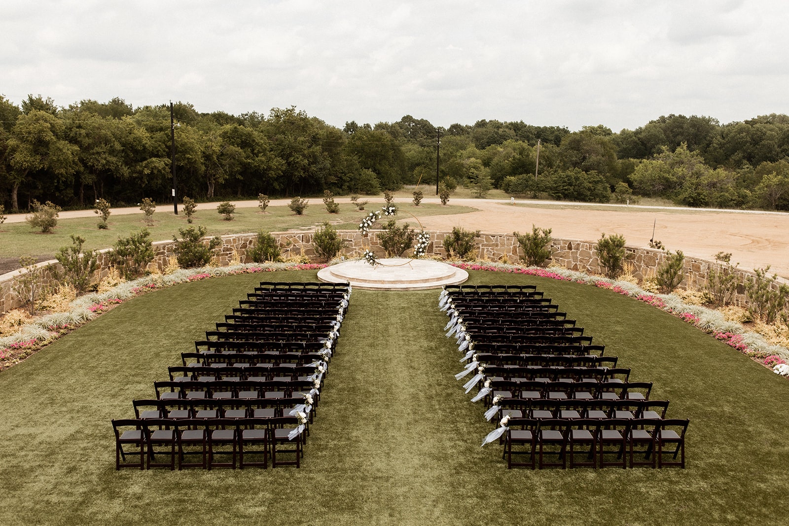 Black wood chairs lined up for outdoor wedding ceremony at D'vine Grace Vineyard