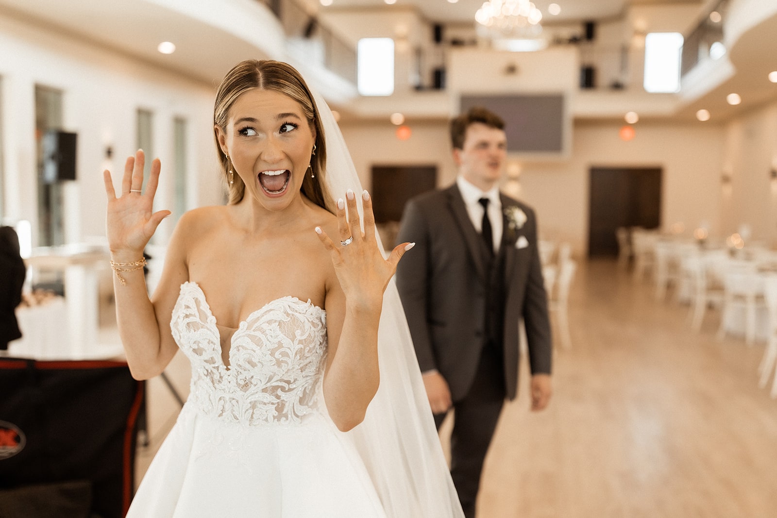 Bride raises her hands in excitement after her North Texas wedding ceremony