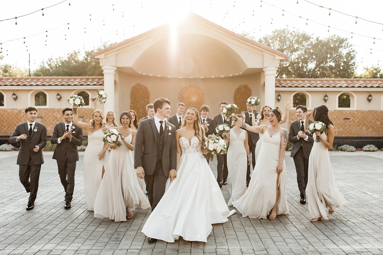 Bride and groom walk with wedding party at their North Texas wedding