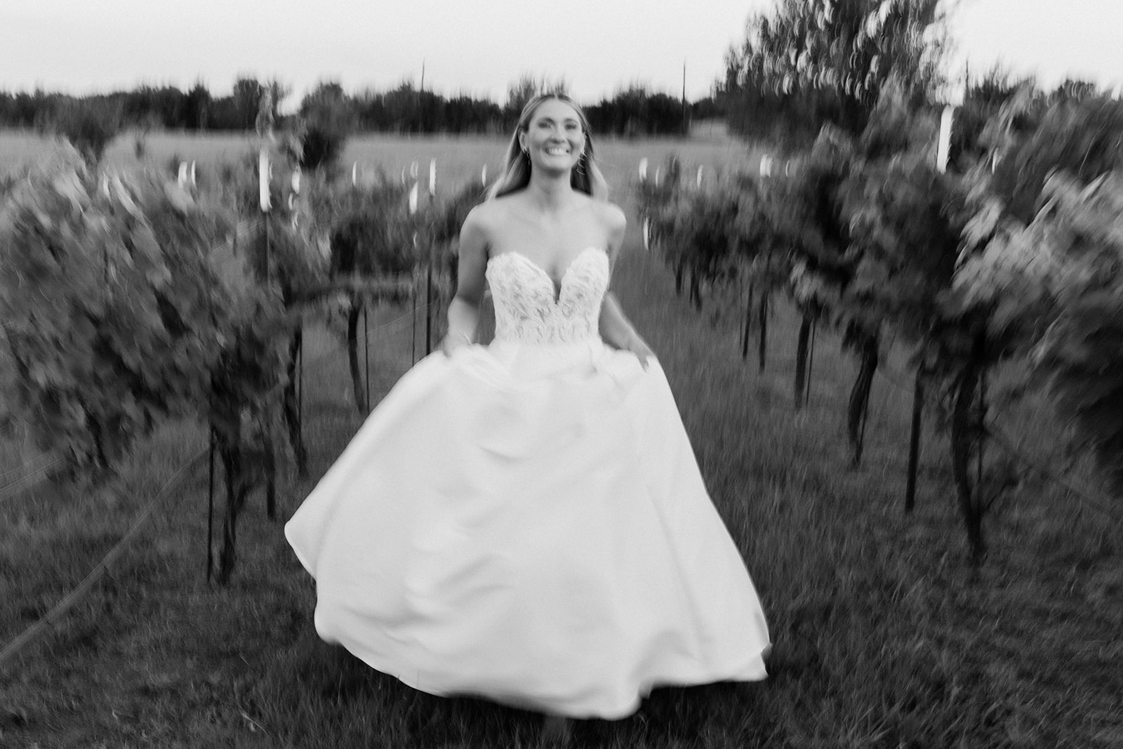 Bride runs through the vineyard at her Italy-themed north Texas wedding