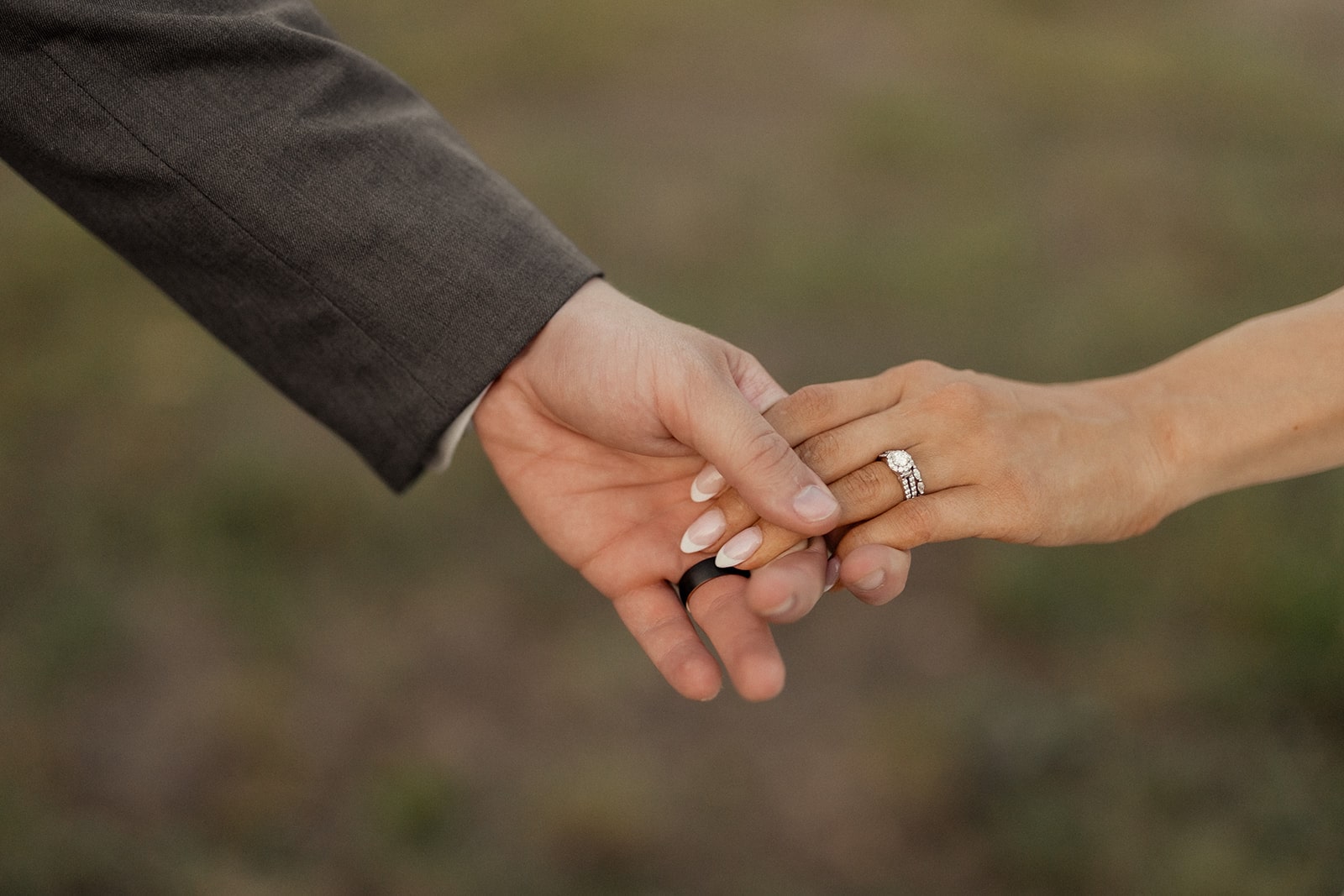 Bride and groom hold hands in the vineyard at D'vine Grace Vineyard wedding venue