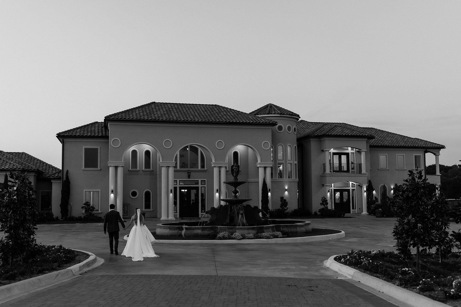 Bride and groom hold hands as they walk back toward their dinner reception at their north Texas wedding