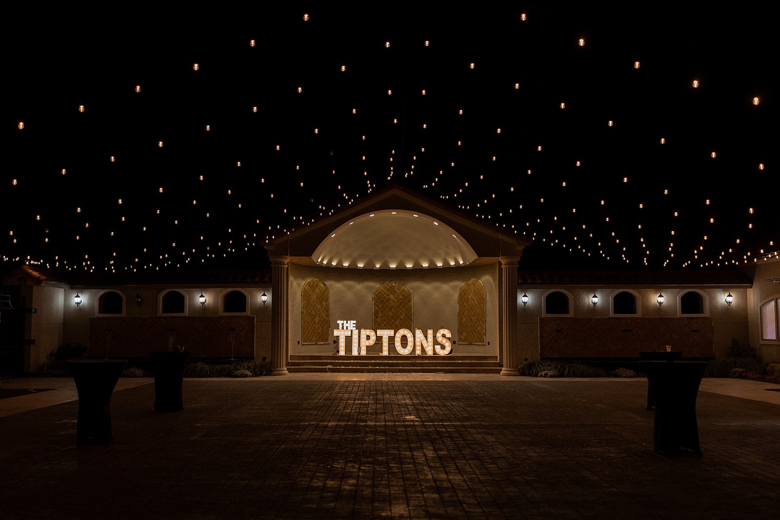 Custom marquee letters lit up under string lights at a north Texas wedding venue