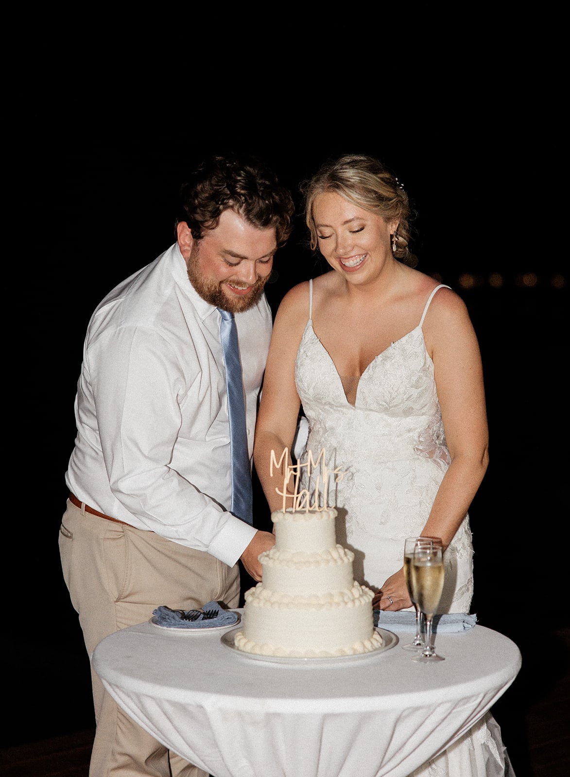 Bride and groom cut their three tier white wedding cake at their Montego Bay Jamaica wedding reception