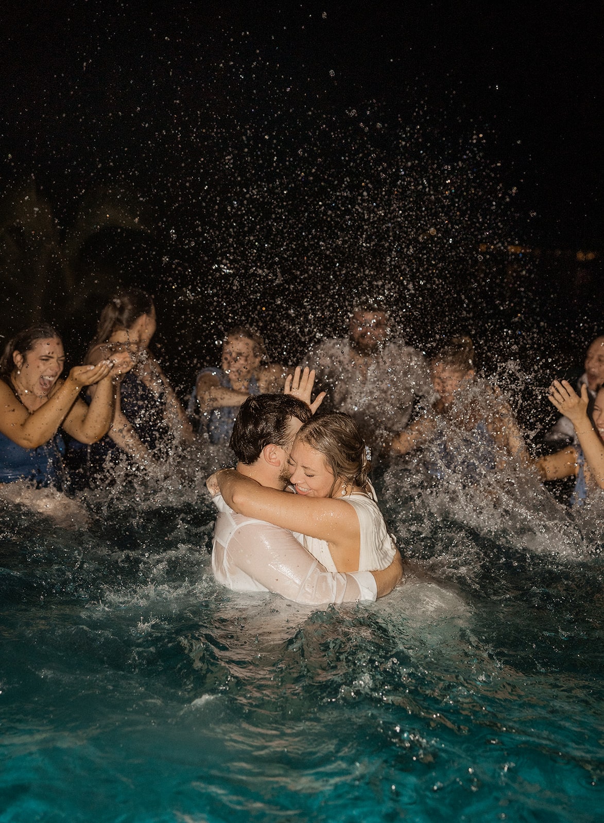 Bride and groom hug in the pool at their Essence Oyster Bay Resort wedding in Jamaica