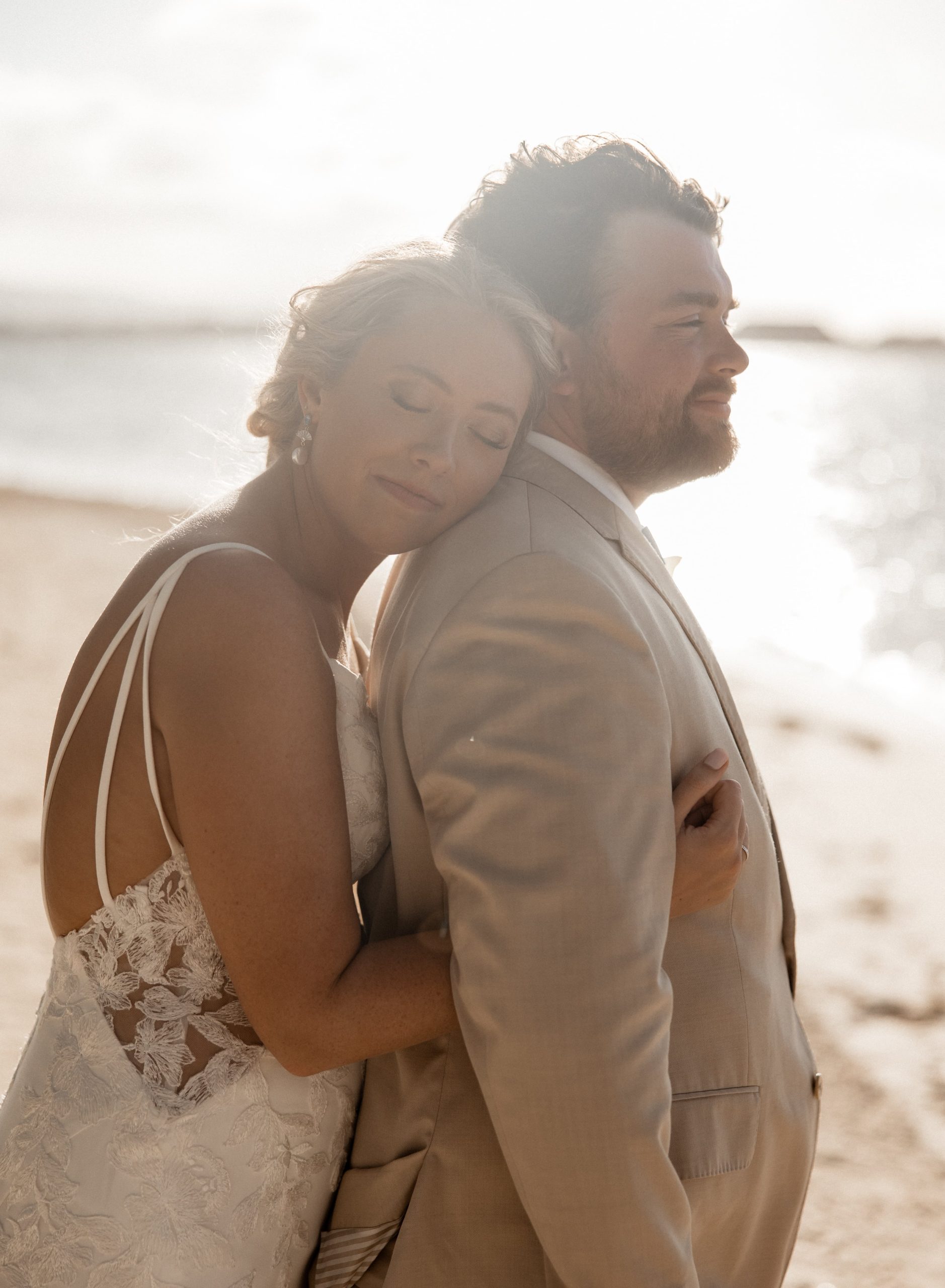 Bride rests her head against groom's shoulder during their Jamaica destination wedding photos