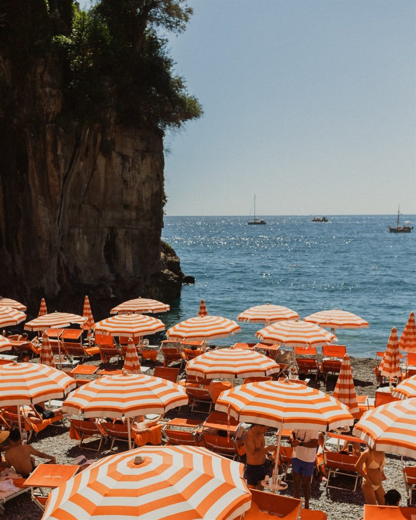 Red and white umbrellas on a beach on the Amalfi Coast