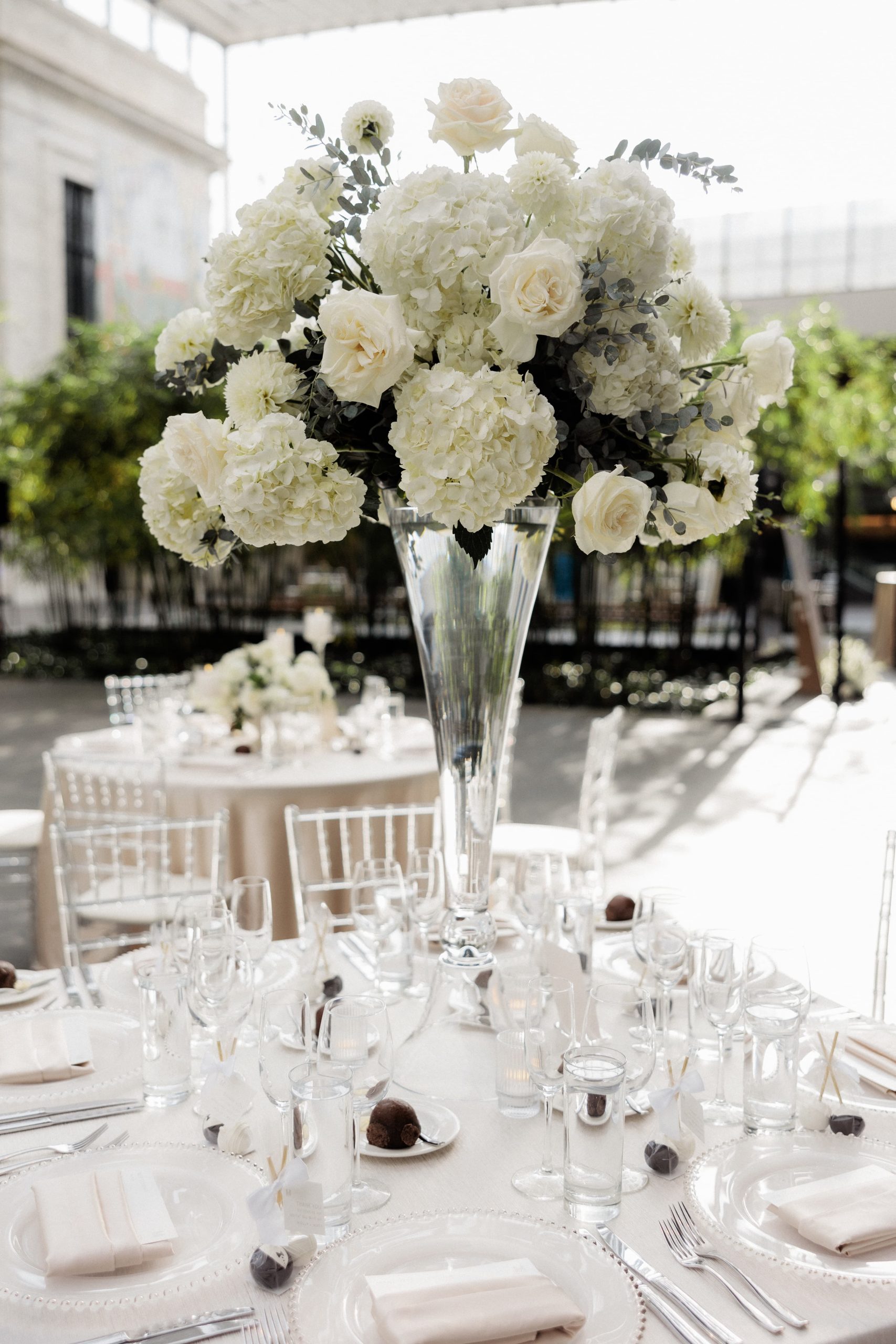 Tall all white wedding flower centerpiece on an all white reception table at the Cleveland Museum of Art