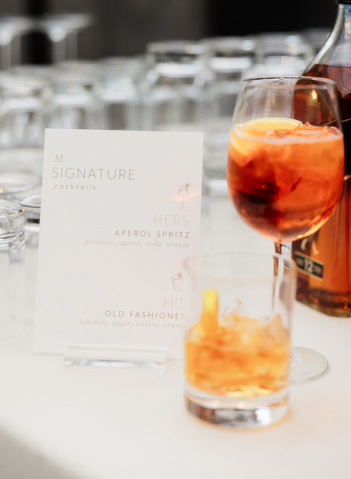 White signature cocktail sign with aeperol spritz and old fashioned cocktails