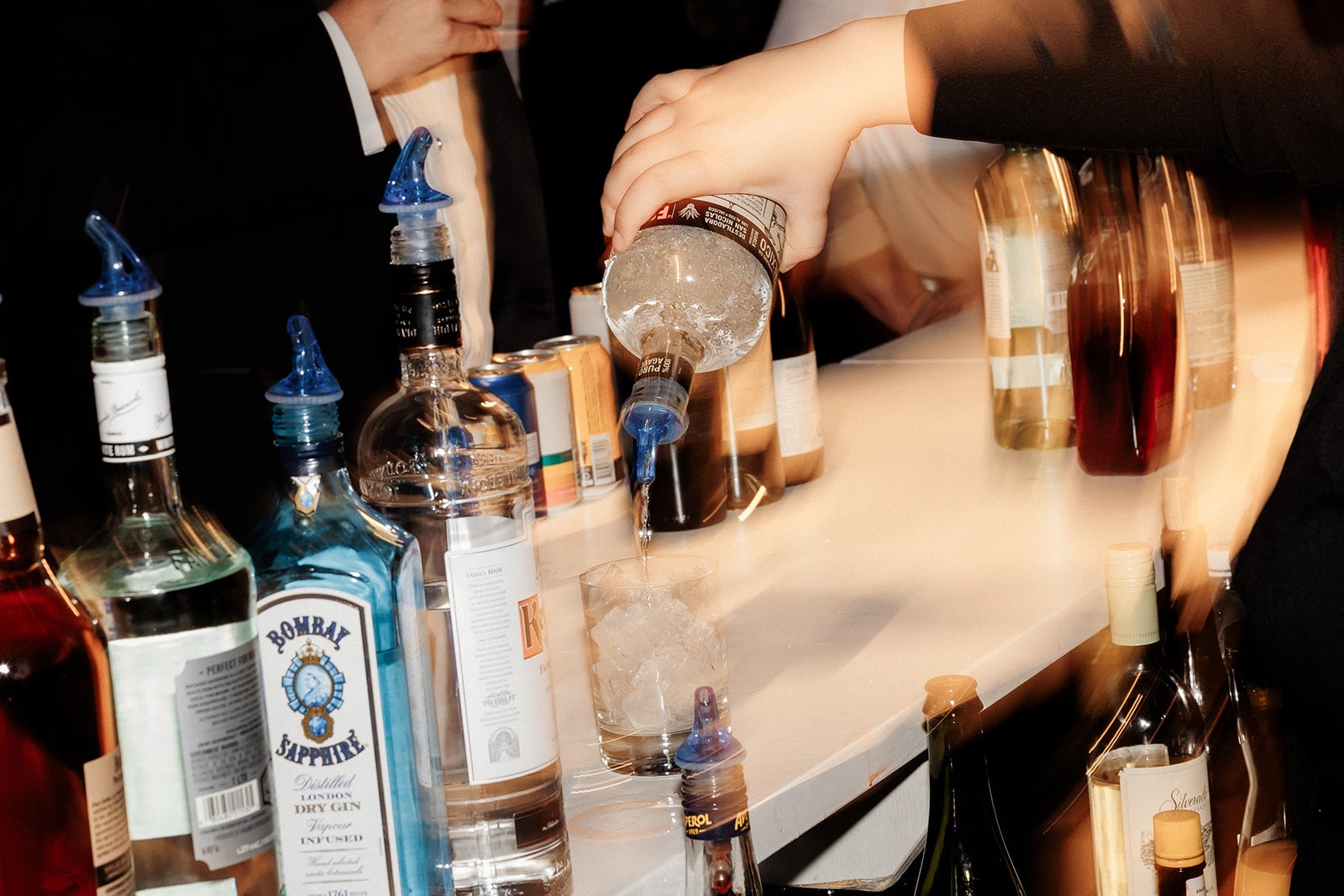 Servers pour alcohol during a museum wedding reception 